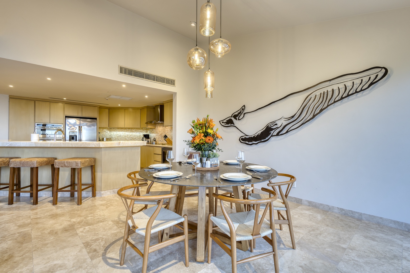 Picture yourself gathering around this stunning dining table under elegant pendant lights, with the open-plan kitchen making meal prep a breeze for your group.
