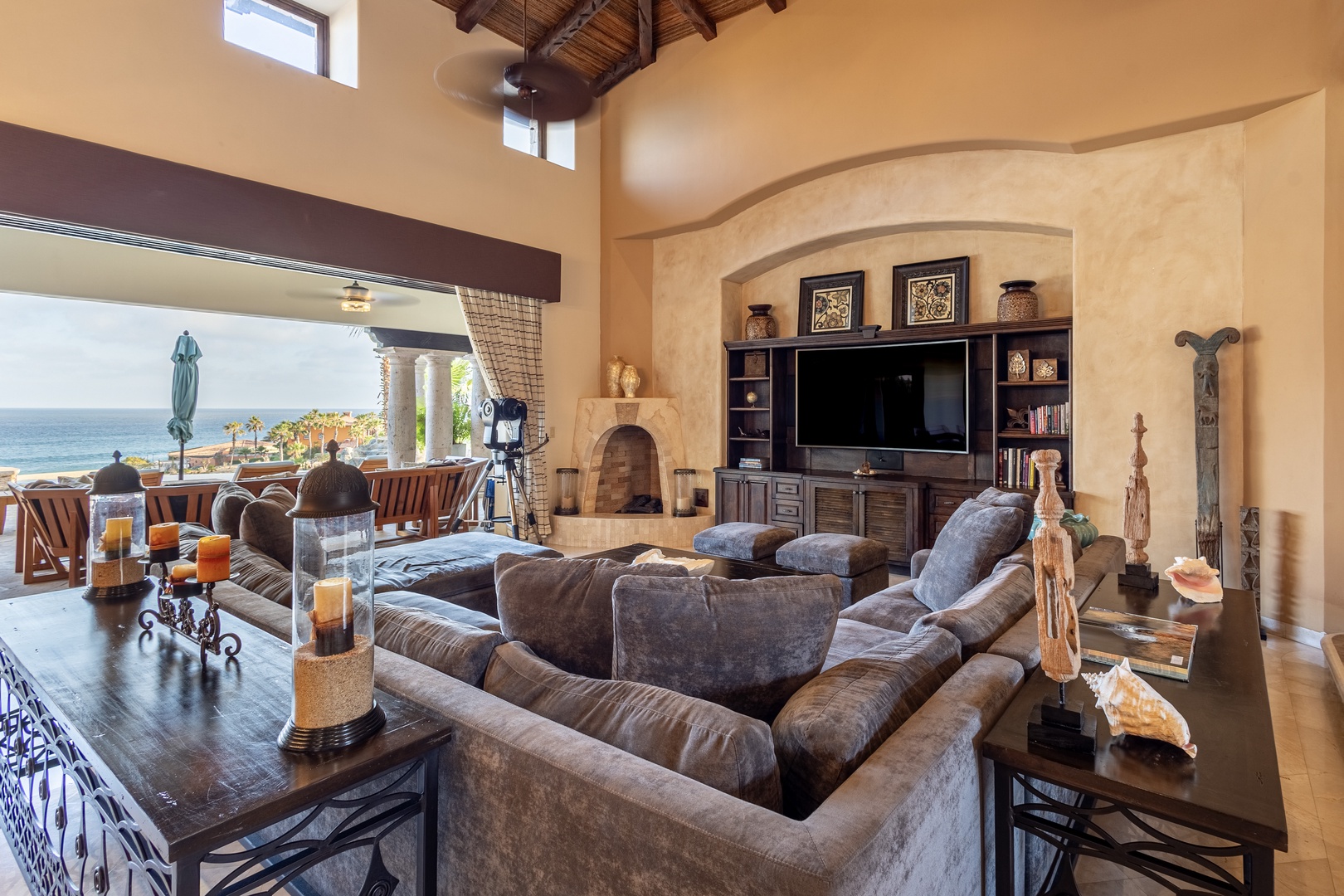 Sink into plush seating with ocean breezes and glittering blue views just beyond. Your living space blends rustic charm with modern comforts—perfect for unwinding after a day of adventure.