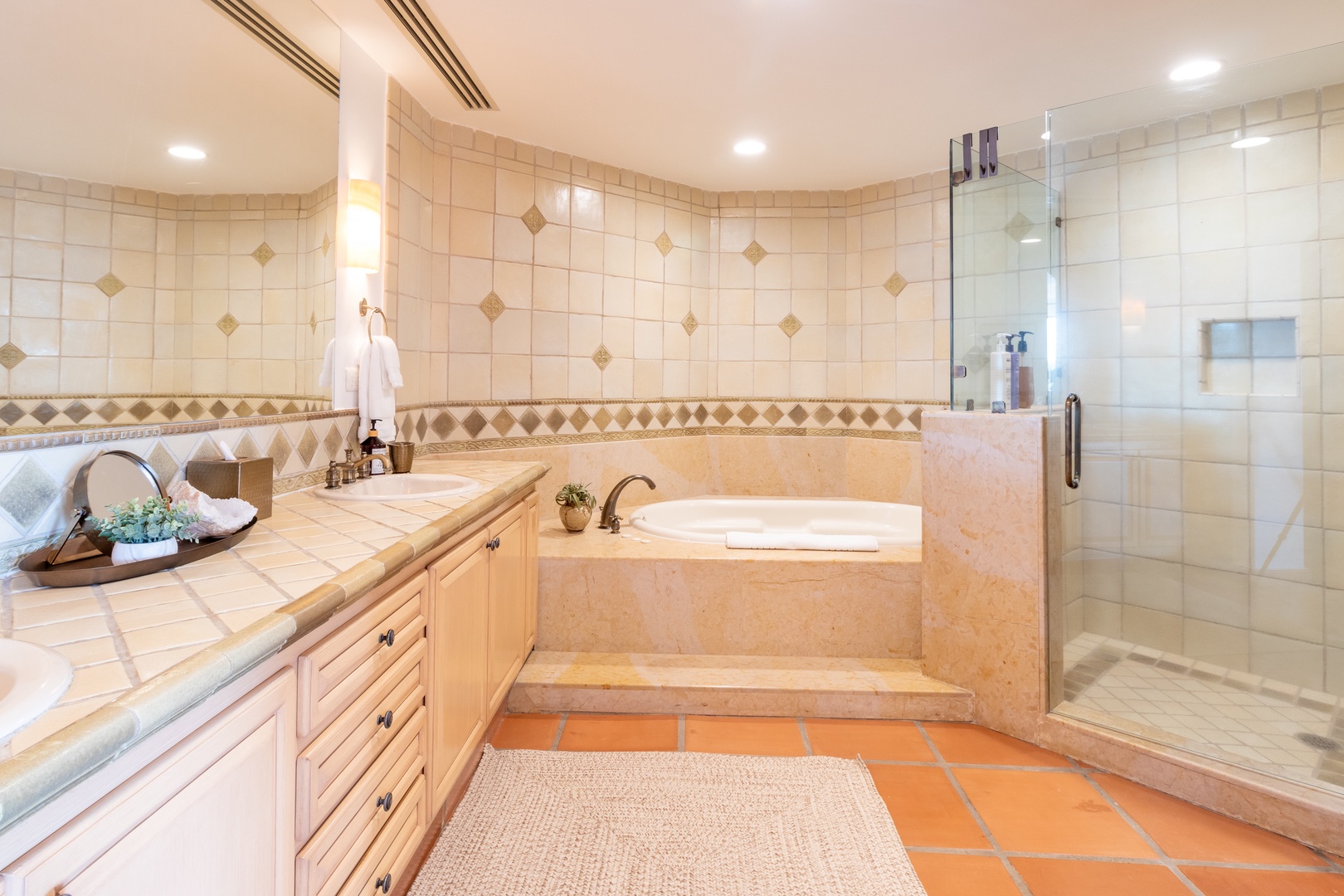 Unwind in your spacious ensuite with warm tile, a soaking tub, and walk-in shower—perfect for melting away the day after exploring nearby attractions.