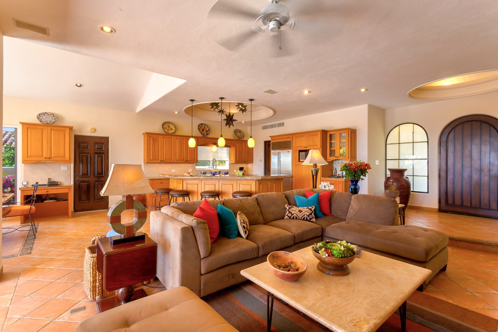Relax in your spacious open-plan living area with plush seating, vibrant accents, and a fully equipped kitchen perfect for memorable meals together.