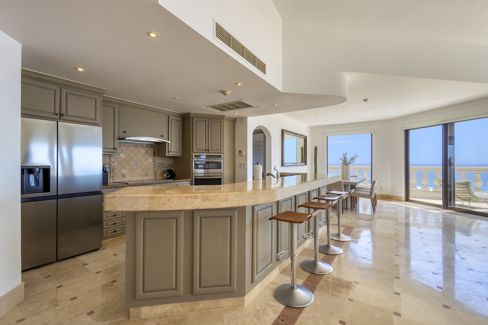 Picture yourself cooking in this stunning kitchen with sweeping sea views at your fingertips. The breakfast bar invites casual meals, while the open design flows seamlessly onto your private terrace.