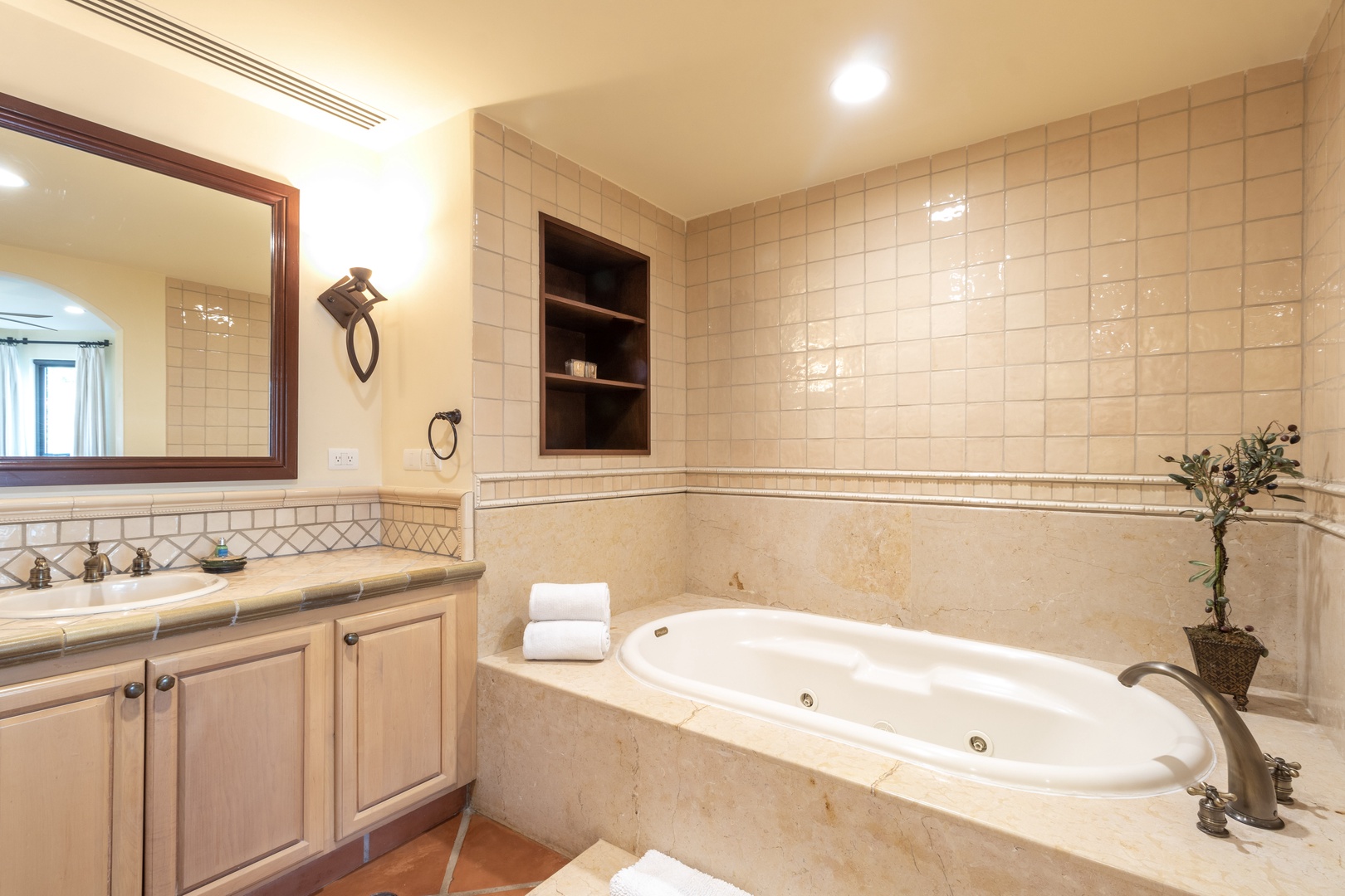 Sink into your private spa-style soaking tub after a day of adventure. Soft lighting, warm tones, and elegant tile create a serene retreat.