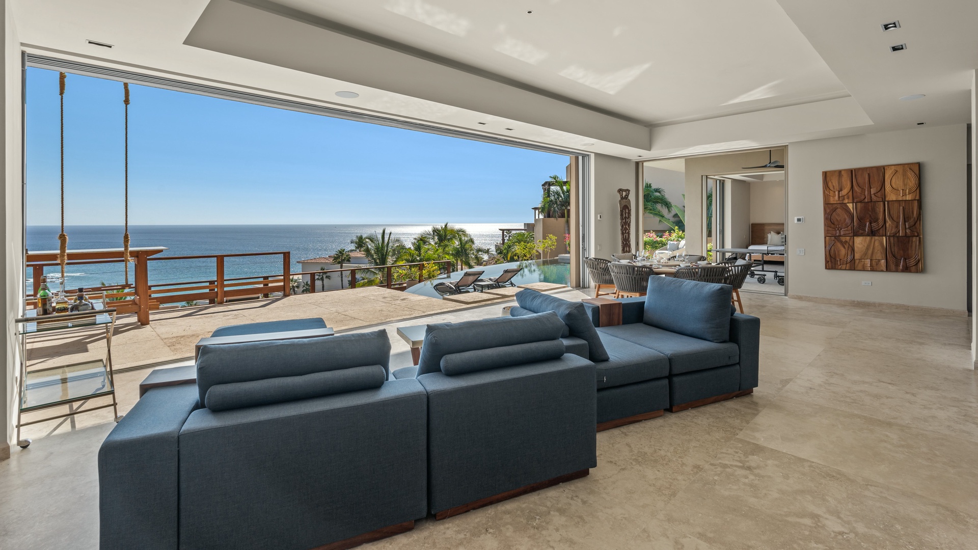 Step into your open-concept living space where sleek modern design meets breathtaking ocean views through floor-to-ceiling windows, inviting you to unwind in sophisticated comfort.