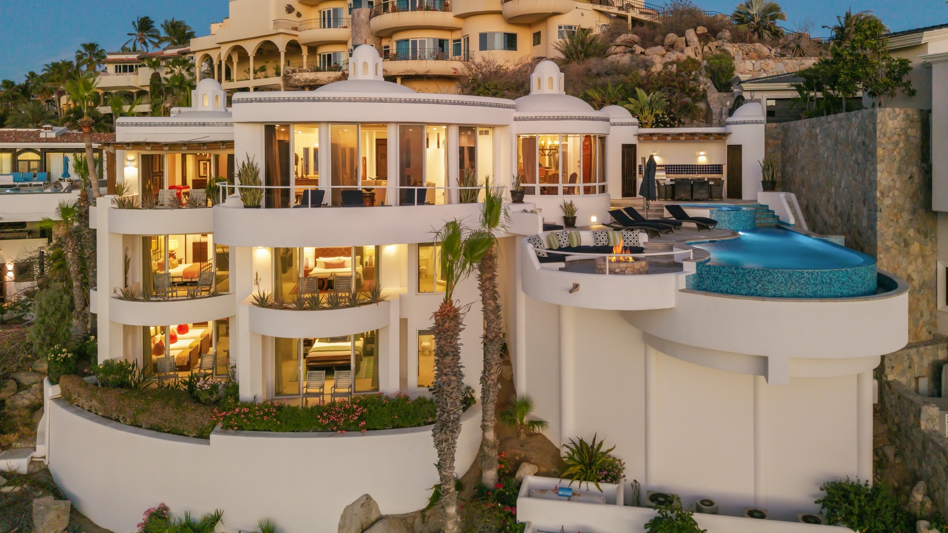 This stunning hillside villa features contemporary architecture with cascading terraces and an infinity pool overlooking the coastline.