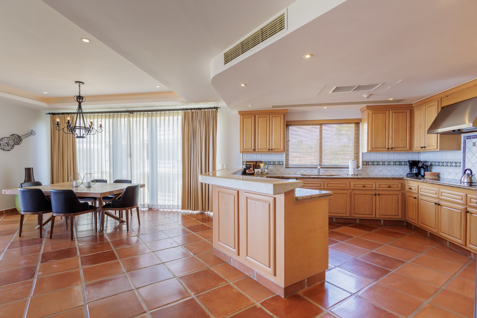 Your fully-equipped kitchen flows into a sunlit dining area where you can gather with loved ones, all under high ceilings with modern climate control and plenty of counter space.