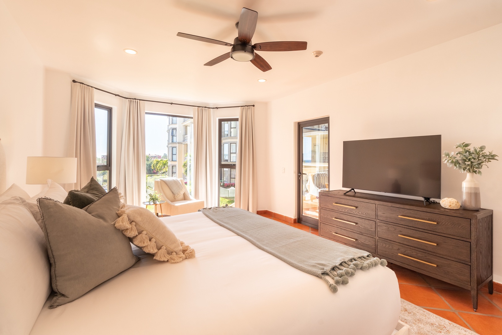 Relax in your serene bedroom with a plush king bed, fresh linens, and calming neutral tones. Wake to natural light streaming through floor-to-ceiling windows, your private balcony just steps away.
