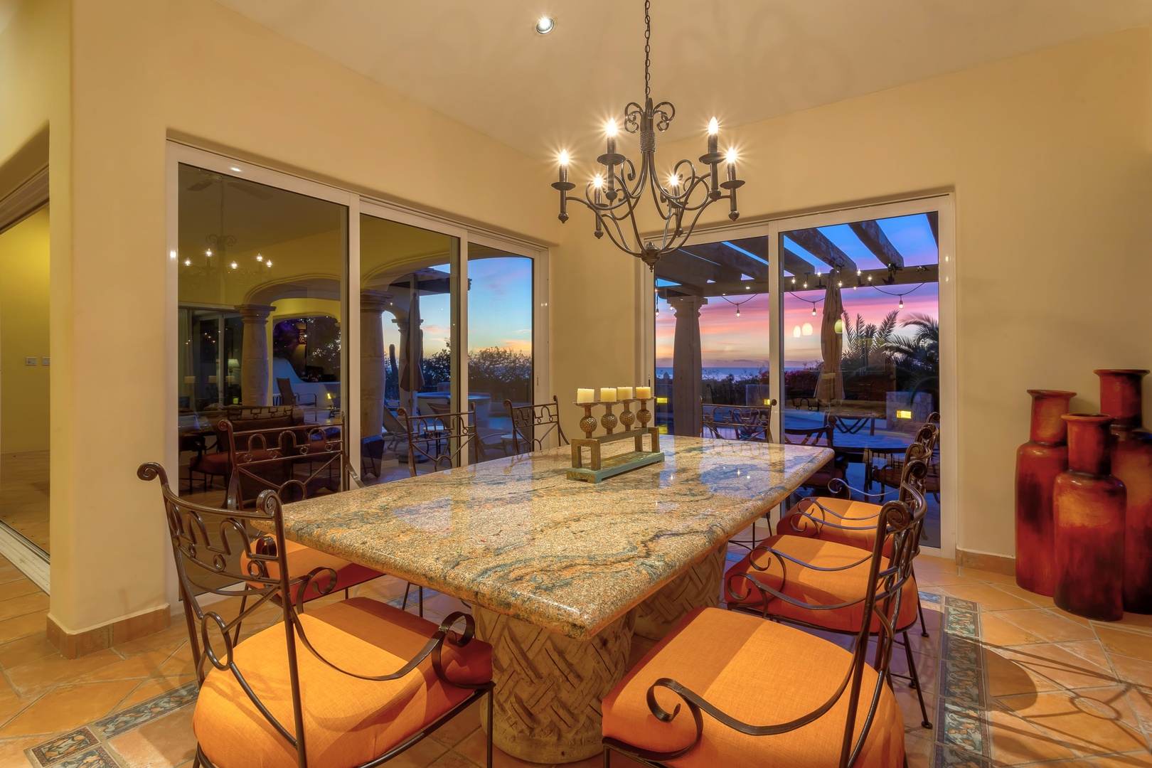 Gather around this stunning granite island as sunset paints the sky beyond your terrace, creating magical moments.