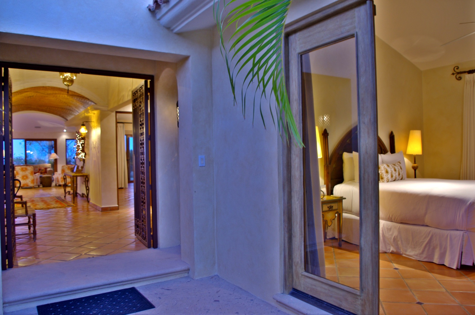 Your private sanctuary opens to a tranquil courtyard, where soft evening light spills from your inviting bedroom. Step through arched doorways into elegantly tiled living spaces, perfect for unwinding after exploring.