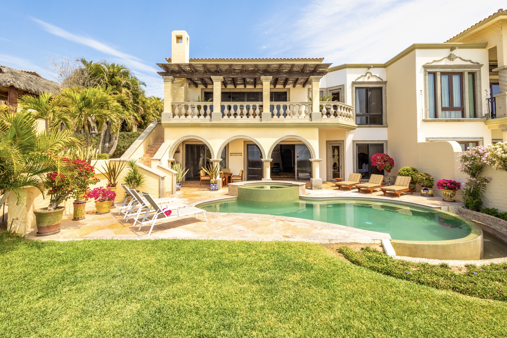 Relax poolside on the sunny terrace, surrounded by tropical gardens and architectural charm. Enjoy serene mornings on the loungers or unwind beneath the arches of this beautiful villa.