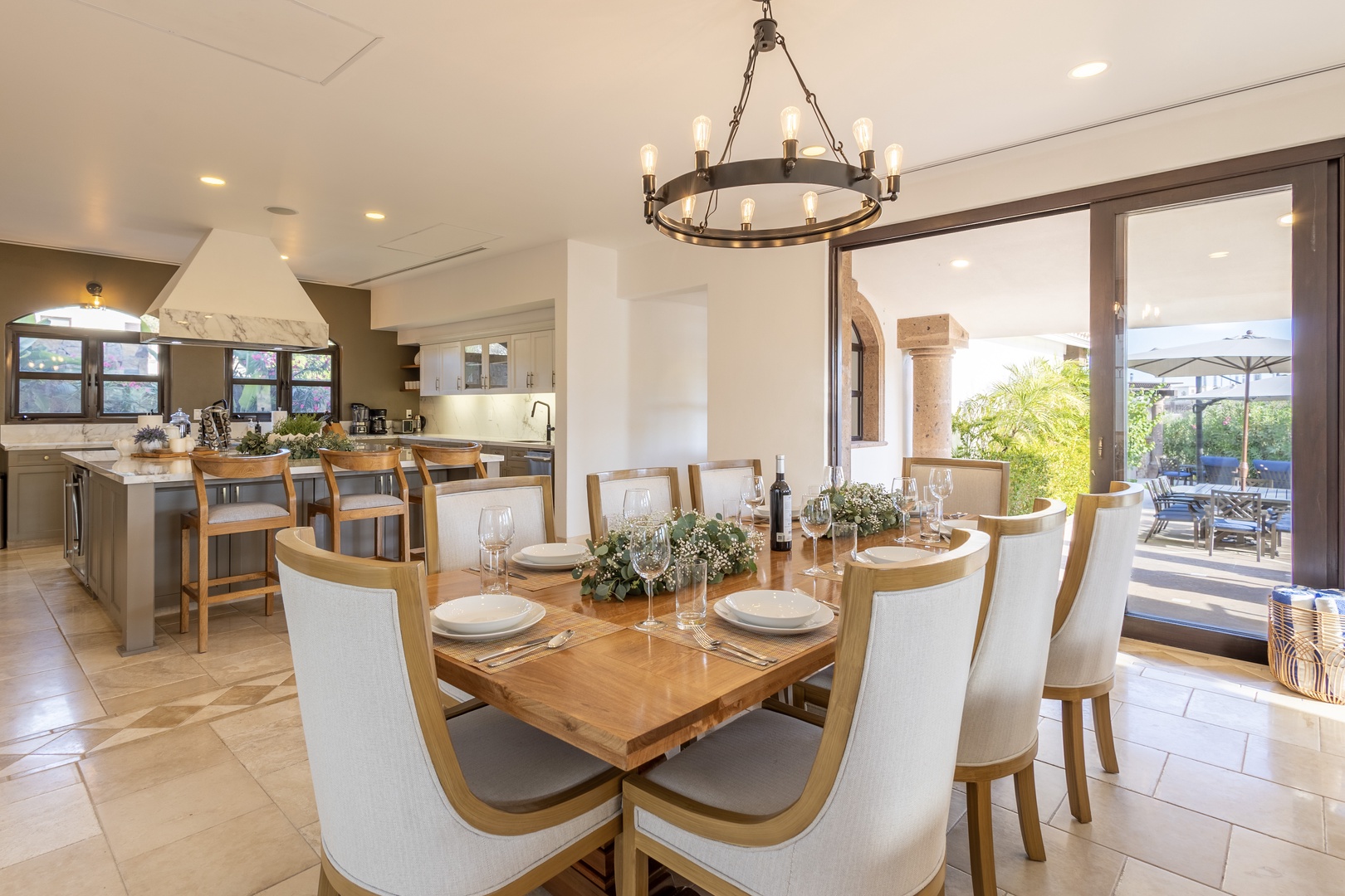 Gather around the gorgeous wood dining table for meals together, with the open kitchen nearby and natural light streaming through to the patio beyond. You'll love the warm, inviting space for sharing stories.