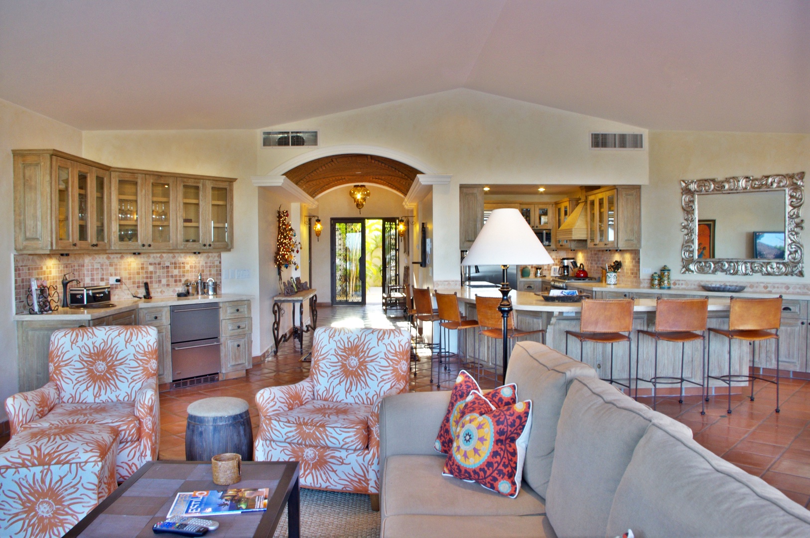 Sunlight pours through French doors into your spacious open-plan living area, where vibrant furnishings, a gourmet kitchen, and a welcoming breakfast bar invite you to unwind and gather together.