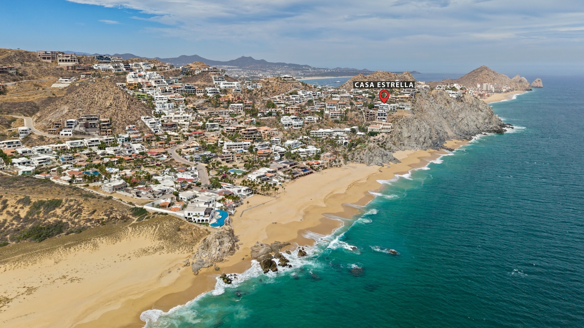 Stunning aerial view shows Casa Estrella's prime beachfront location along pristine coastline with turquoise waters and golden sand beaches.