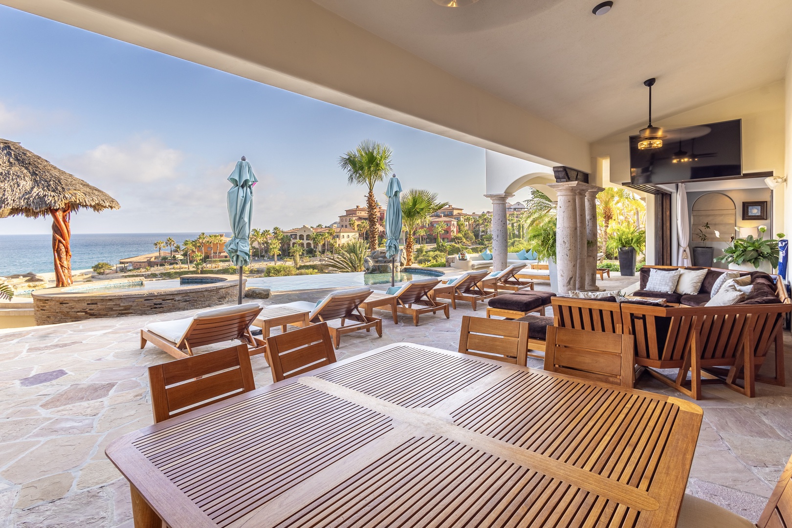 Lounge on teak sunbeds and soak in stunning ocean views from your expansive covered terrace, perfectly blending indoor comfort with tropical coastal beauty.