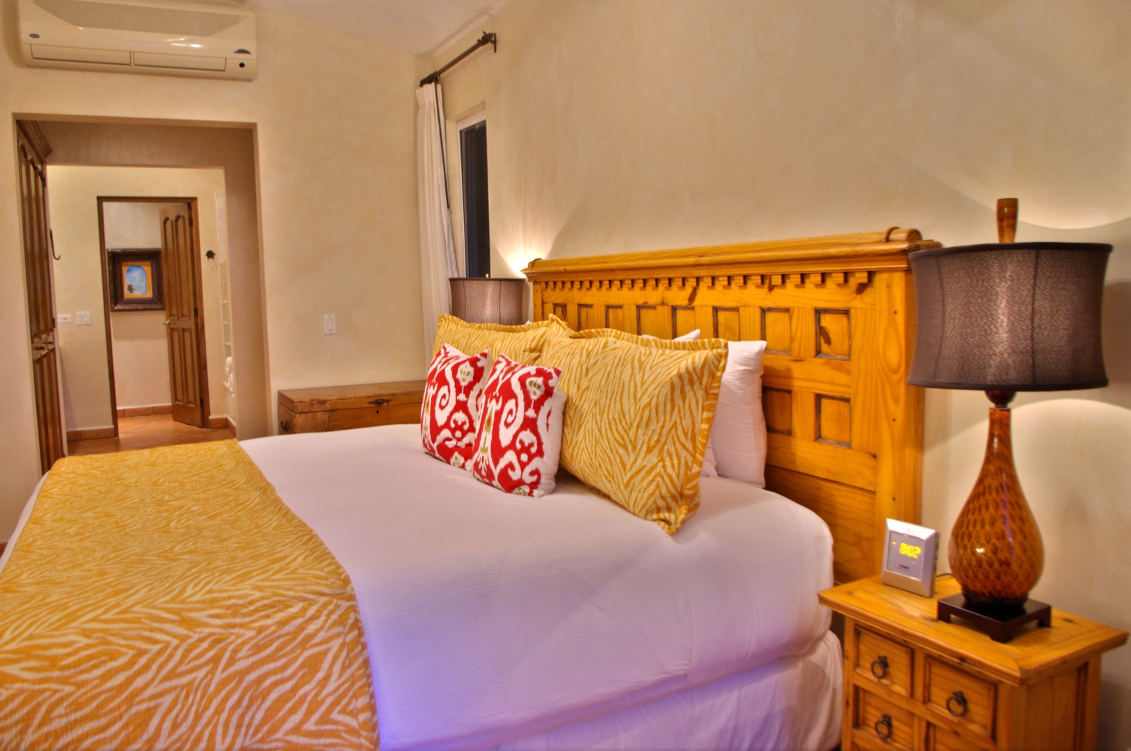 Unwind in your spacious bedroom with elegant wooden furnishings and climate-controlled comfort. The plush bedding and colorful accents create a welcoming retreat after your day of adventure.