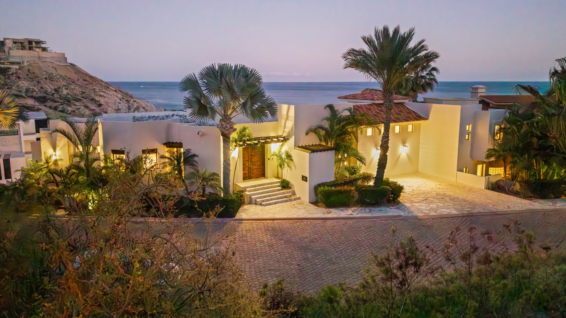 Stunning beachfront villa with tropical landscaping and ocean views creates the perfect coastal retreat setting.