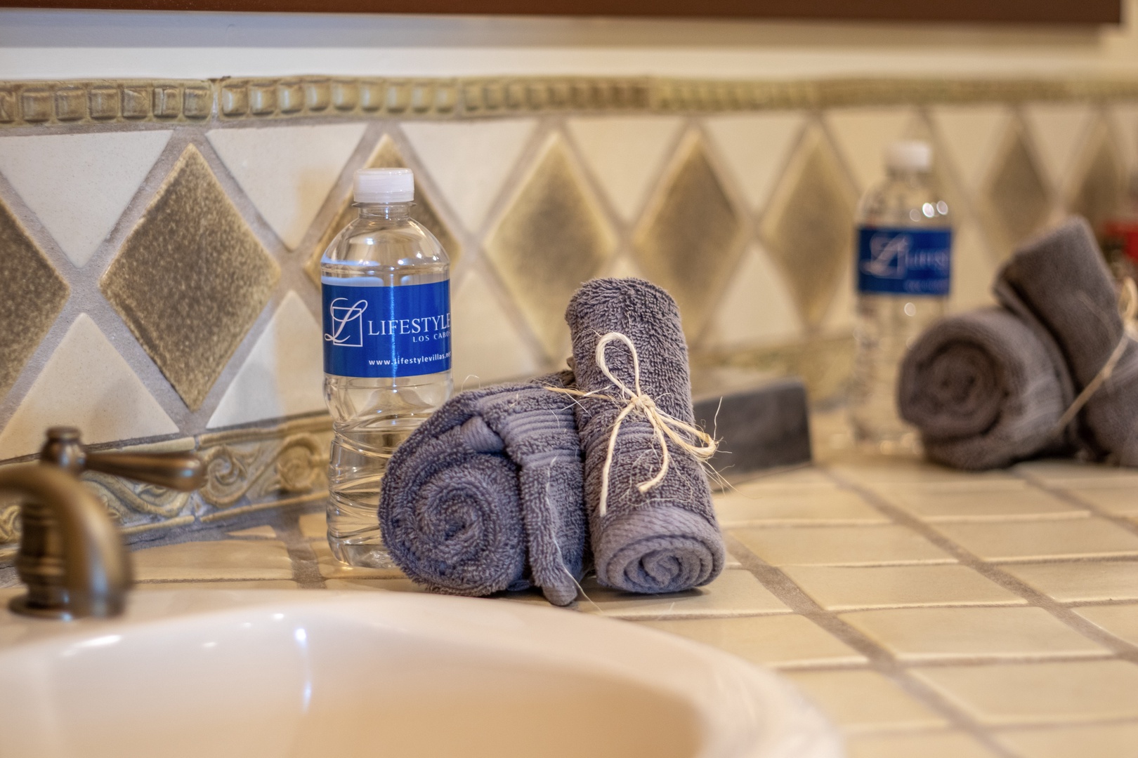 Fresh towels and bottled water await you by the sink, ensuring comfort and convenience throughout your stay.
