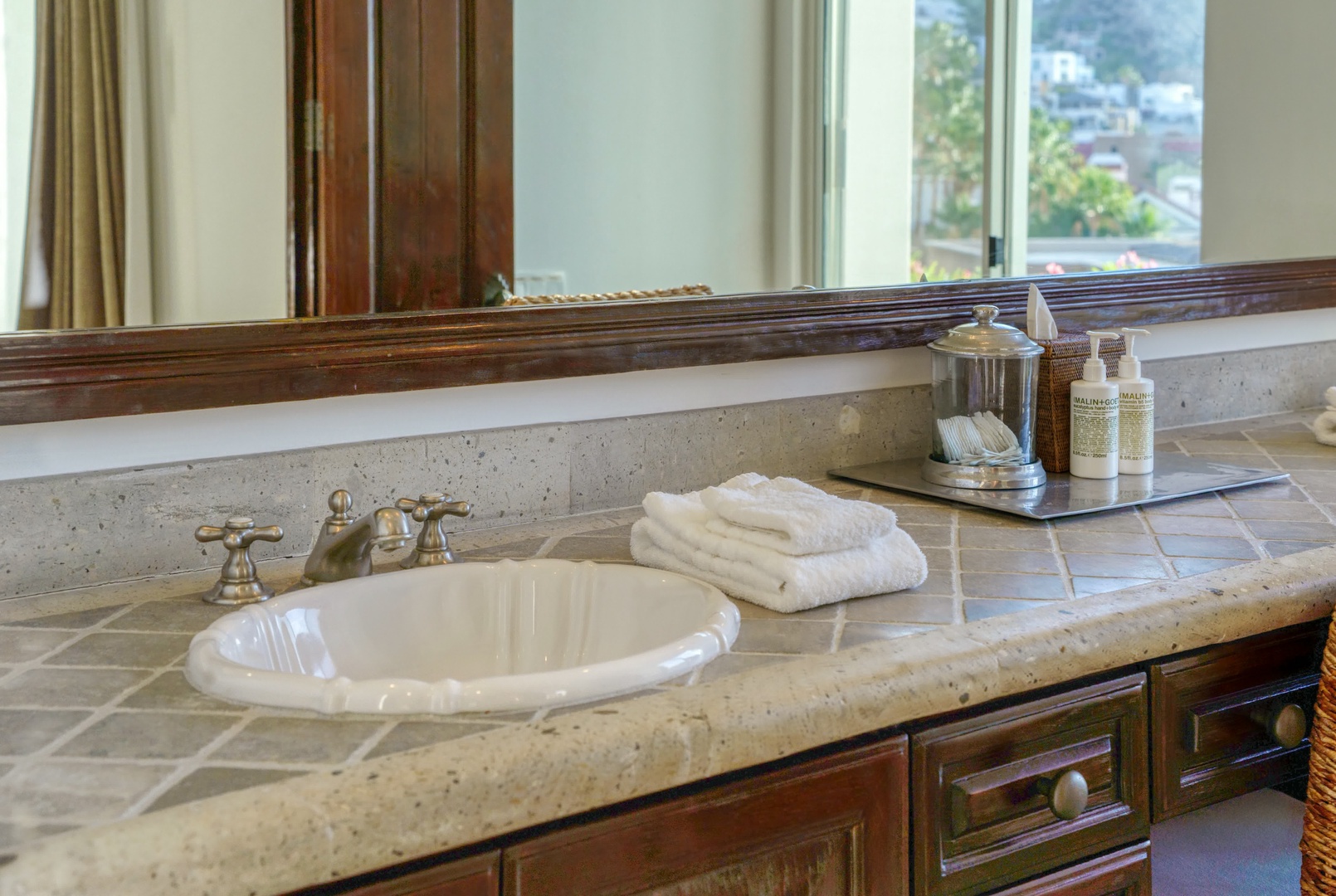 Unwind in your elegant bathroom with plush towels, premium amenities, and peaceful views beyond your window.