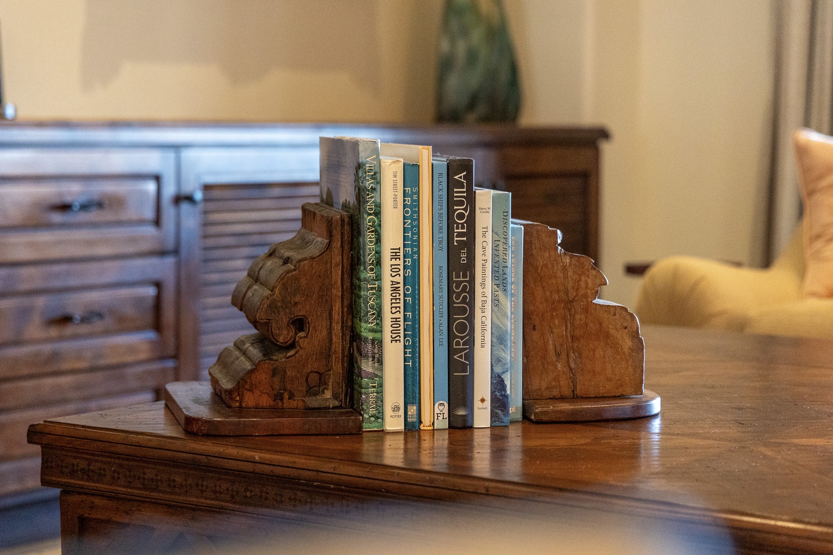 Your bedroom features custom wood furnishings and thoughtful touches like a curated book collection, creating a warm, inviting space for unwinding after your adventures.