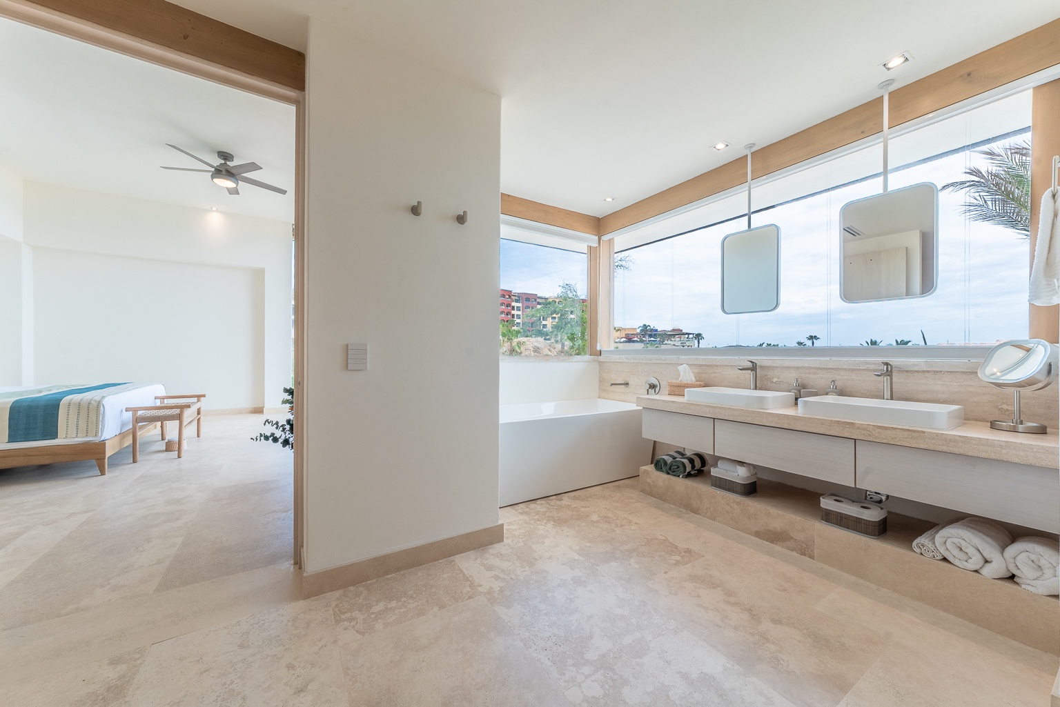 Your spacious ensuite bathroom features dual vanities with natural light, ocean views, and an open layout connecting to your serene bedroom—perfect for refreshing mornings by the coast.