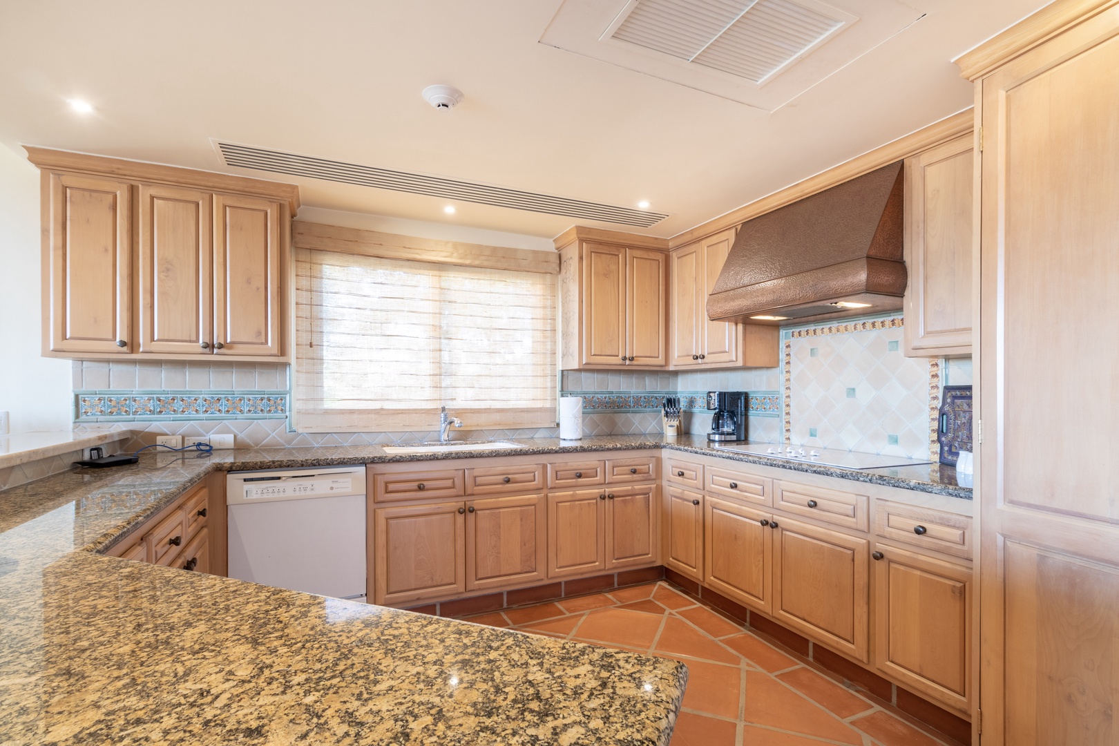 Your spacious gourmet kitchen awaits, featuring granite countertops, ample cabinetry, and modern appliances—perfect for preparing memorable meals during your stay.