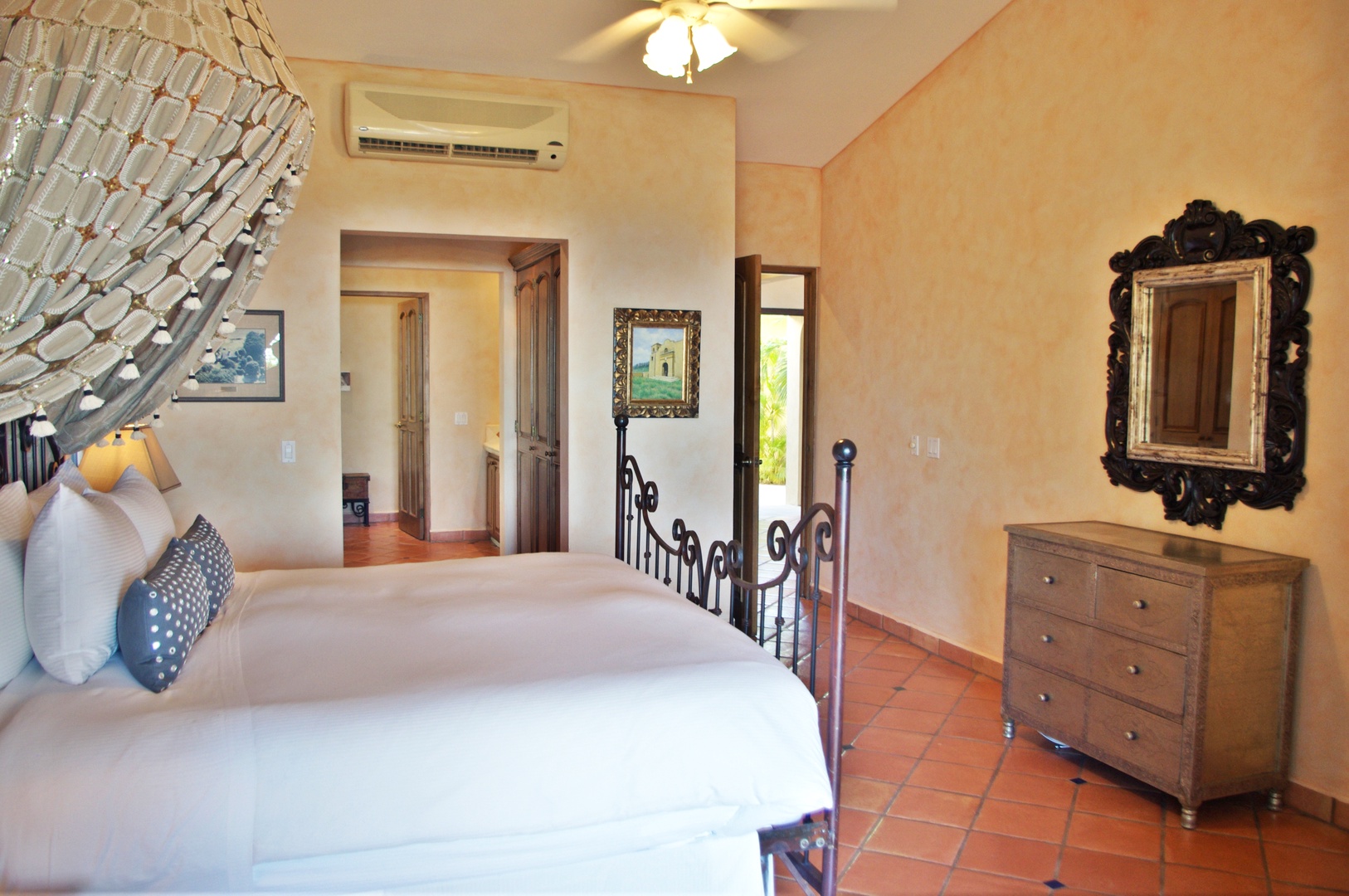 Unwind in your sunlit bedroom where warm terra cotta floors and soft linens invite total relaxation, while modern AC ensures your perfect comfort.