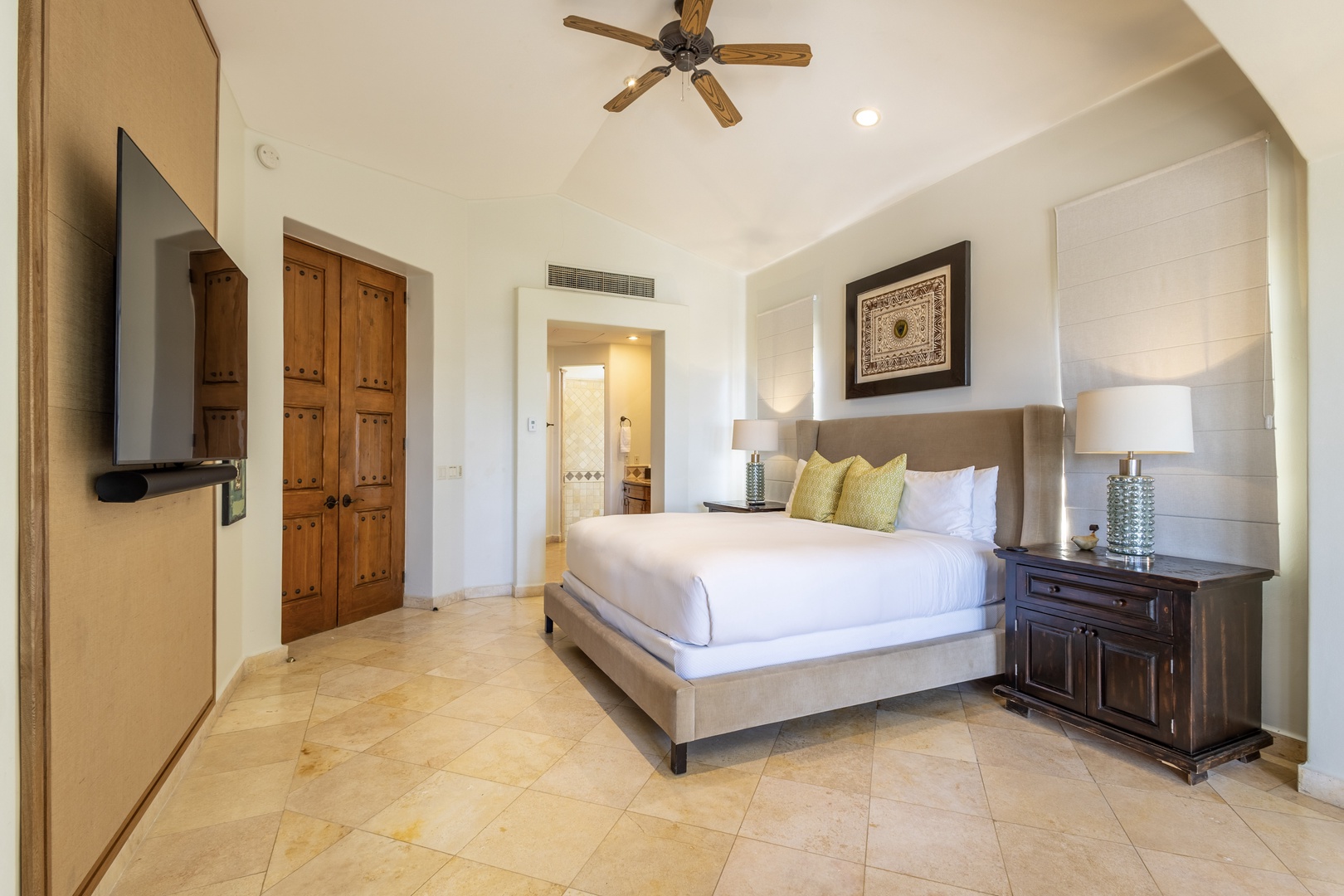 Rest peacefully in your spacious bedroom featuring premium linens, modern amenities, and elegant stone floors for ultimate comfort.