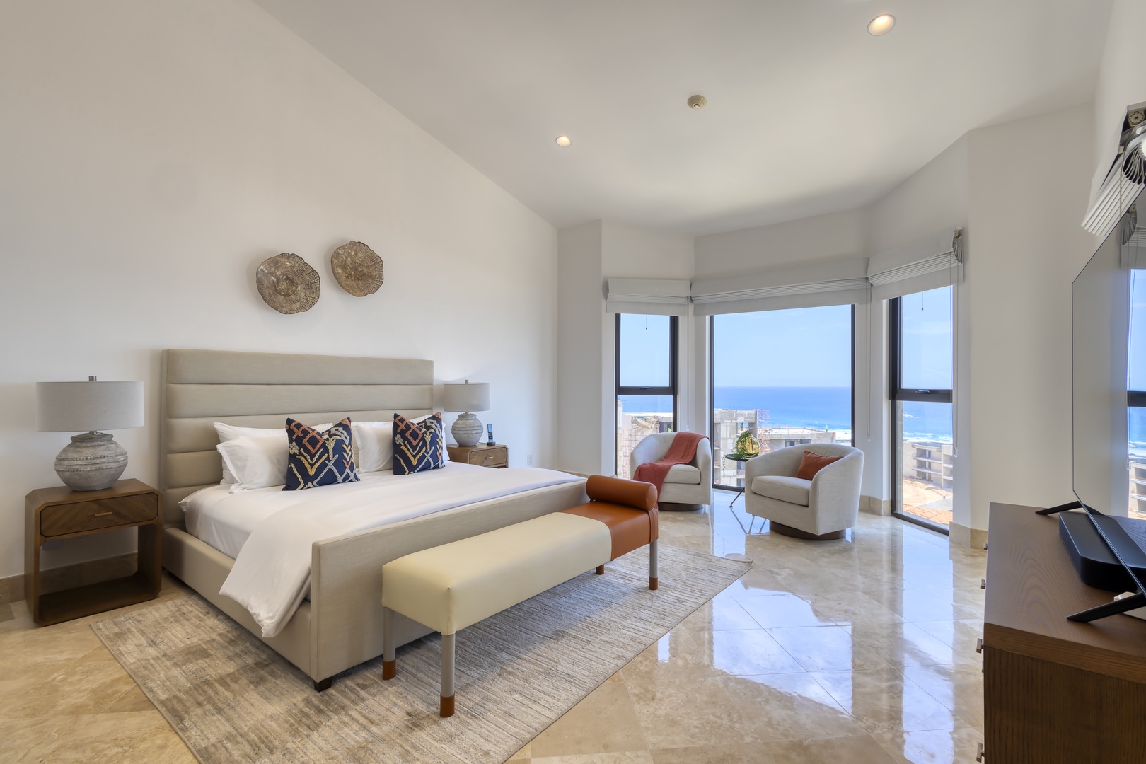 Wake up to stunning sea views from your bright, airy bedroom. Sink into the plush king bed and unwind in your stylish seating nook as sunlight streams through floor-to-ceiling windows.