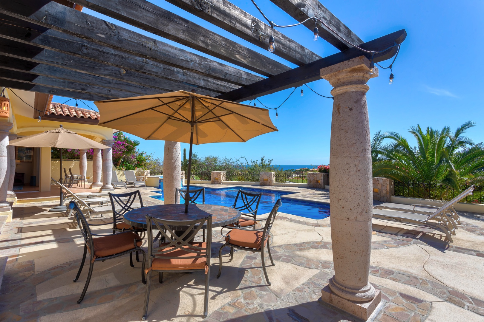 Relax under your private pergola where ocean breezes meet poolside dining—perfect for morning coffee or sunset cocktails with stunning sea views.