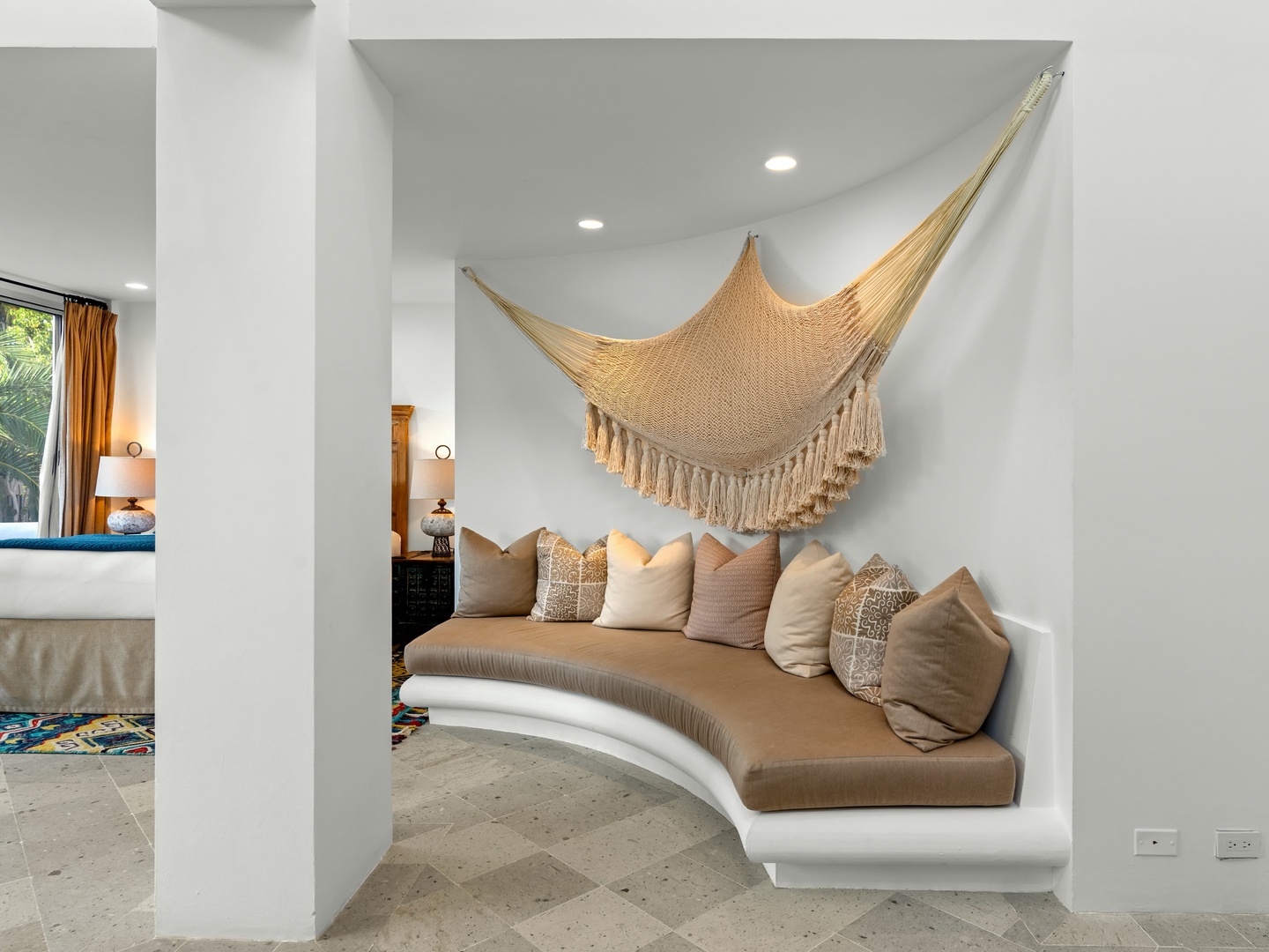 Sink into this dreamy curved daybed beneath a woven hammock, where afternoon siestas become your favorite ritual.