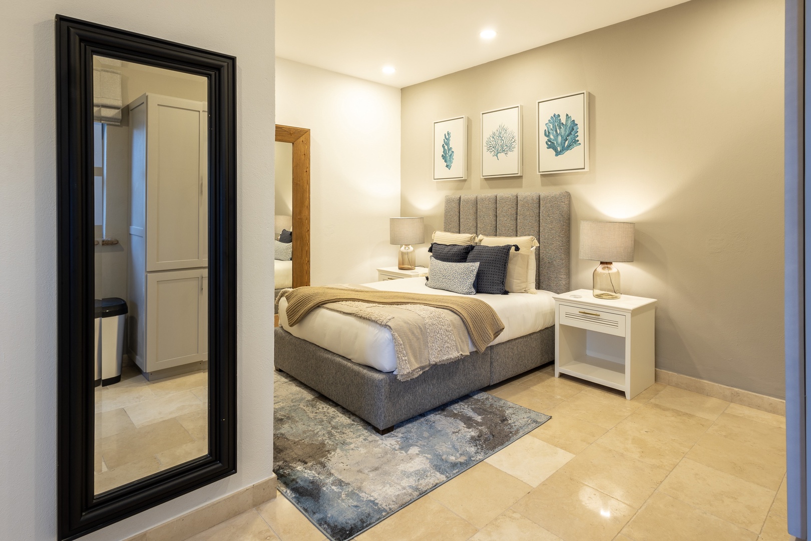 Sink into plush bedding and coastal-inspired décor, where soft lighting and thoughtful touches create your perfect retreat after a day of exploring.