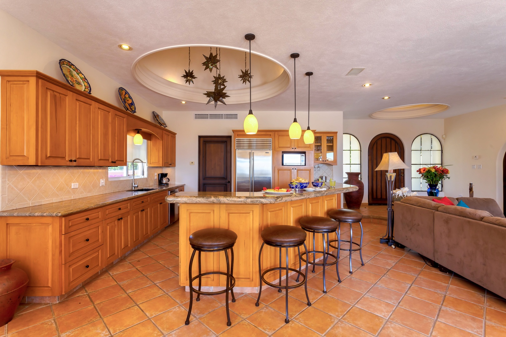 Gather around your spacious kitchen island with granite counters and warm wood cabinetry, where memorable meals begin.