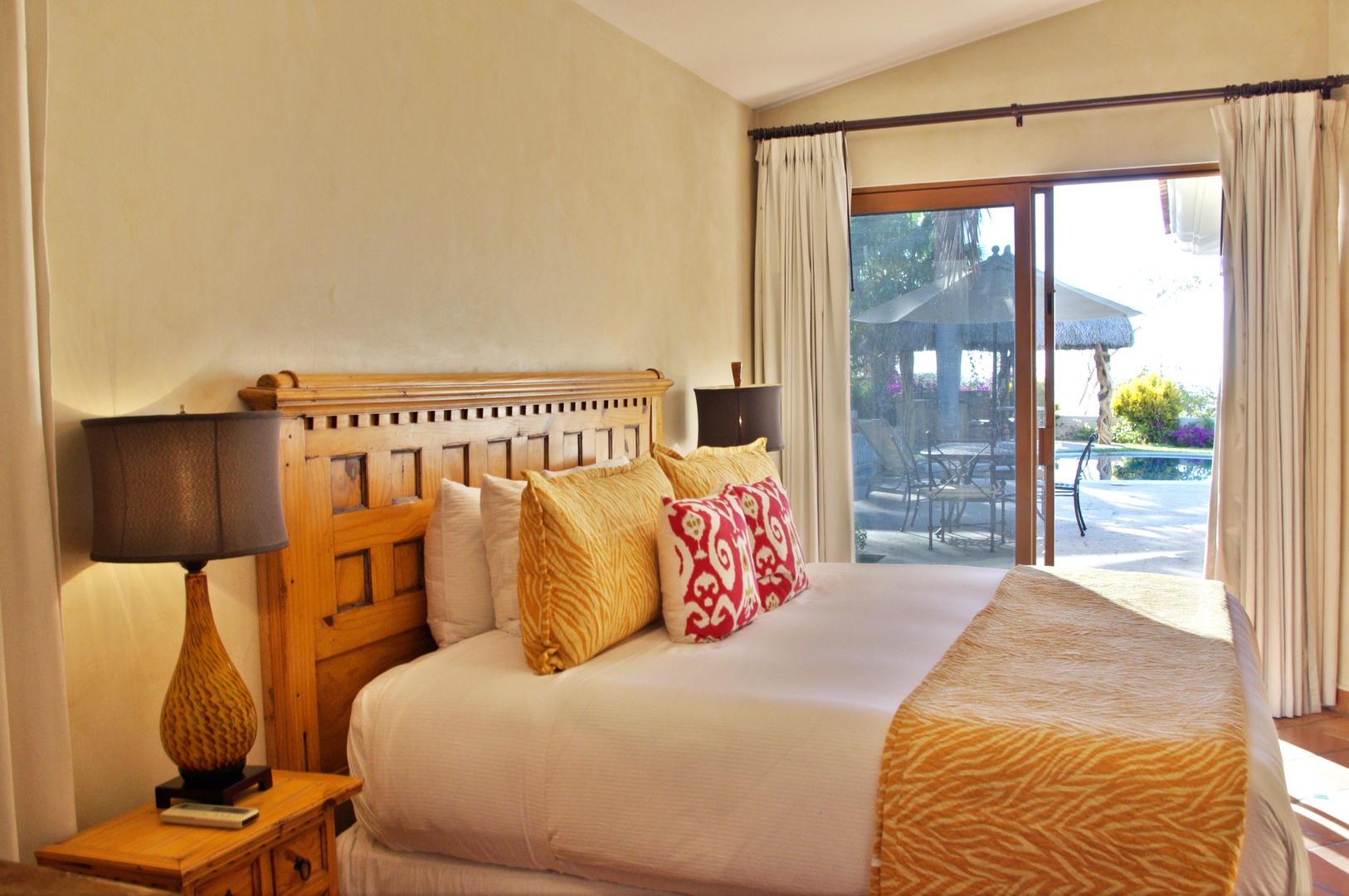 Your peaceful bedroom retreat opens directly to the pool and outdoor terrace, where warm sunlight and tropical breezes invite you to relax in complete comfort.