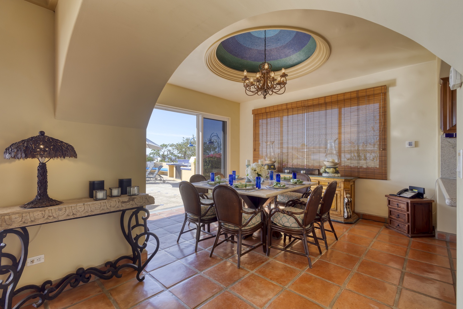 Gather around your elegant dining table beneath the stunning stained glass skylight, where natural light creates magical moments for meals.