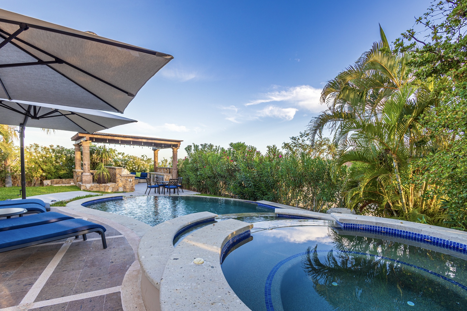 Picture yourself unwinding in your private pool surrounded by lush tropical palms, then soaking in the hot tub as the day fades into a serene evening.