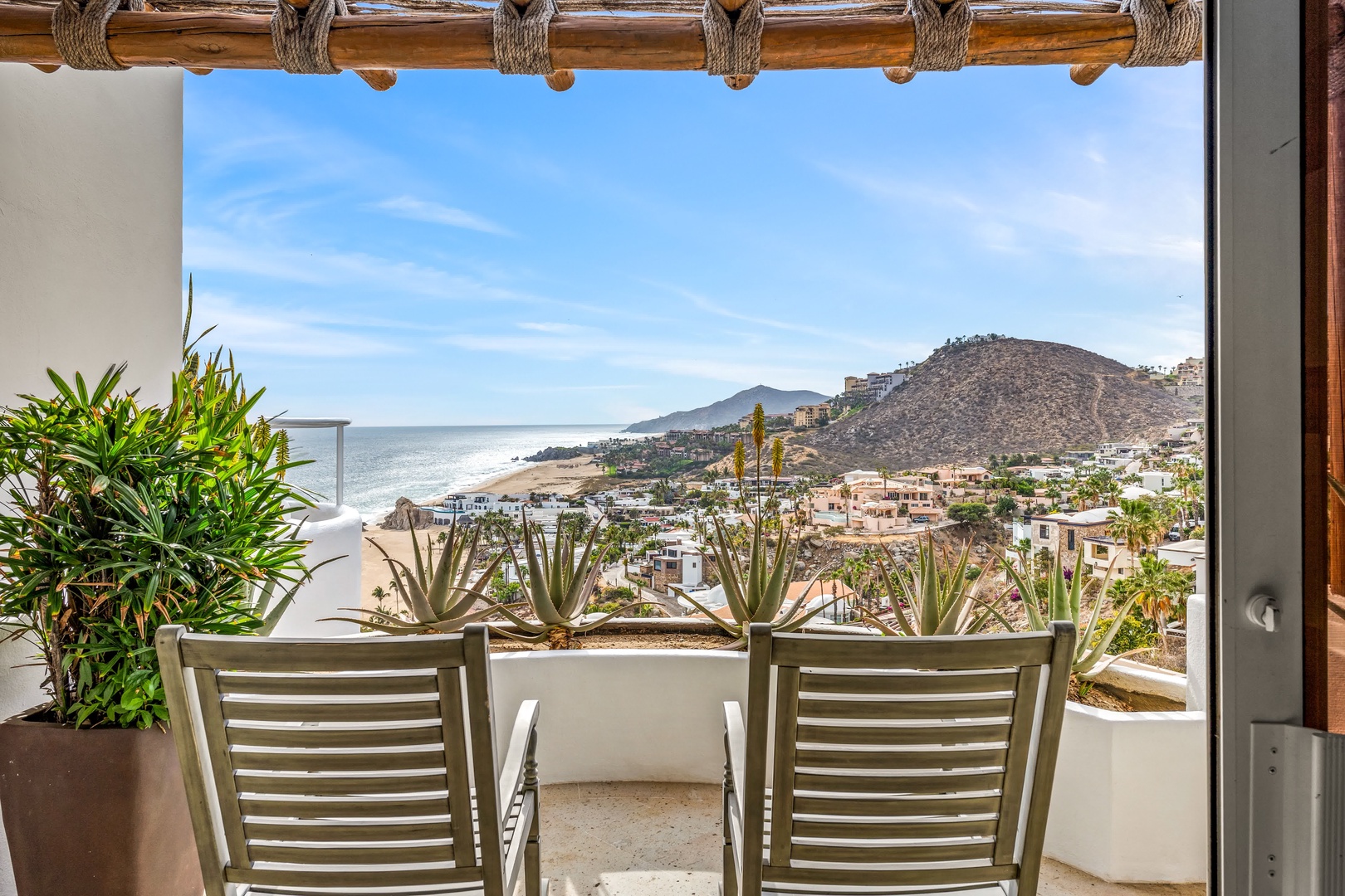 Soak in breathtaking ocean and mountain views from your private terrace, where comfortable seating awaits your morning coffee moments.