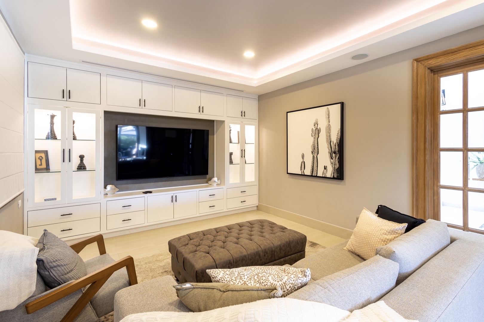 Unwind in your private living room with plush seating, ambient lighting, and a built-in entertainment center perfect for movie nights and relaxation.
