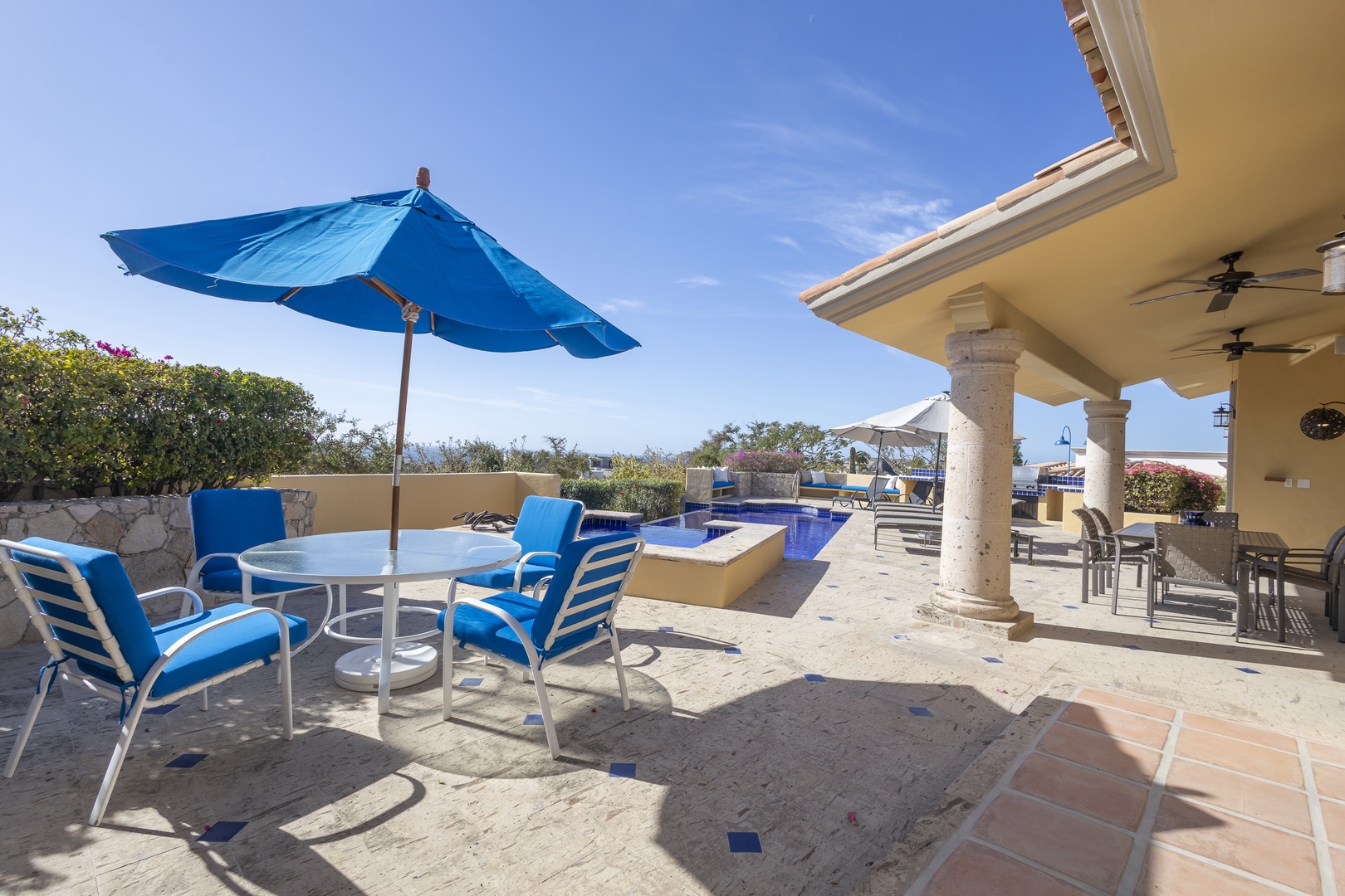 Your private terrace with pool and patio dining awaits under endless blue skies and warm sunshine.