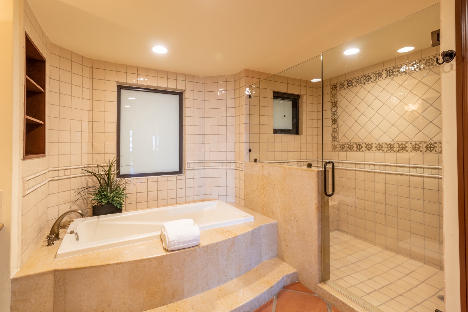 Sink into your private soaking tub or refresh in the spacious walk-in shower, with elegant tile details creating a tranquil spa-like retreat.
