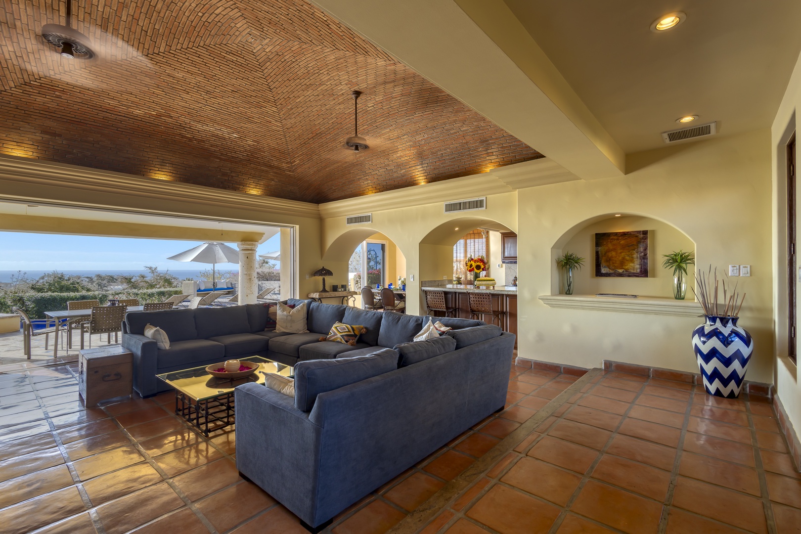 Relax in your elegant living space with soaring brick ceilings and stunning mountain views through floor-to-ceiling windows.