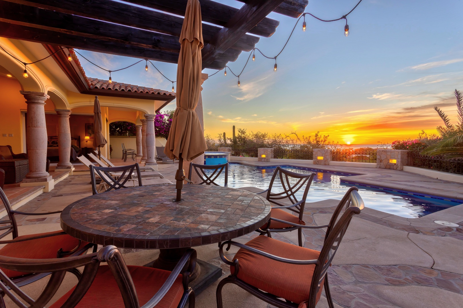 Unwind poolside as golden sunsets paint the sky, with comfortable seating and ambient lighting creating your perfect evening retreat.