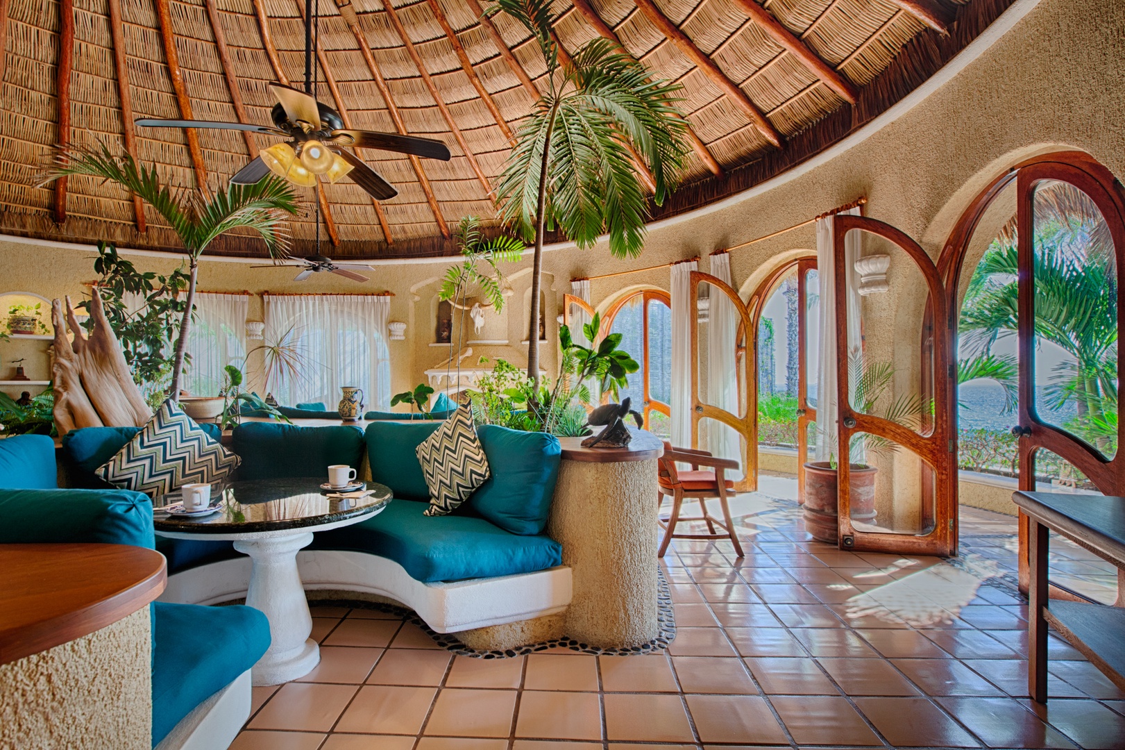 Relax under your private palapa roof where tropical breezes flow through arched doorways and lush plants create your perfect paradise retreat.