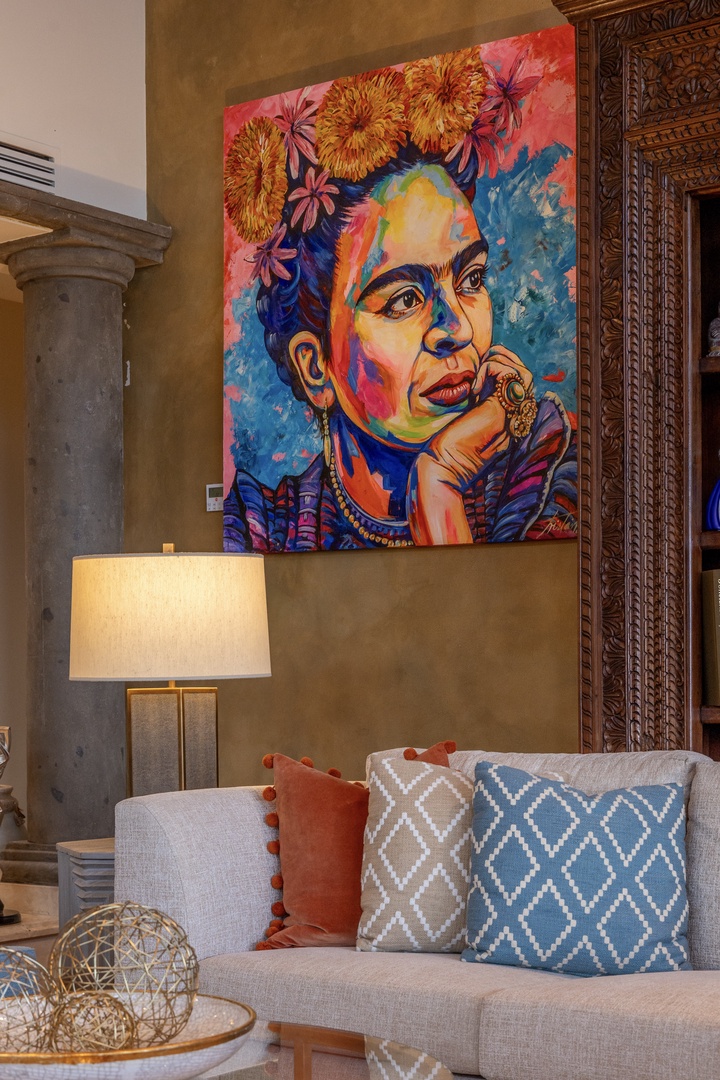 Sink into the plush sofa and admire the vibrant artwork above—your personal gallery awaits in this thoughtfully designed living space.