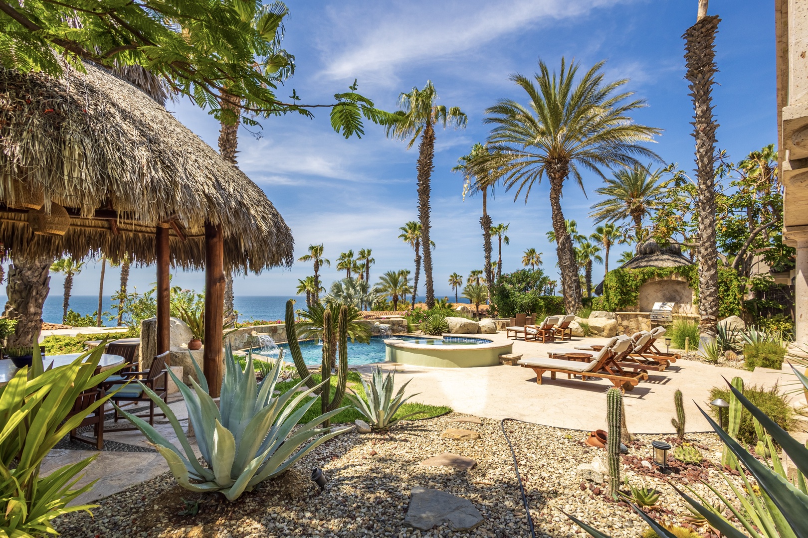 Step into your private tropical oasis where swaying palms frame sparkling pool waters and the sea stretches endlessly beyond. Unwind on sun loungers beneath a palapa or soak in the hot tub, all surrounded by desert gardens and ocean breezes.