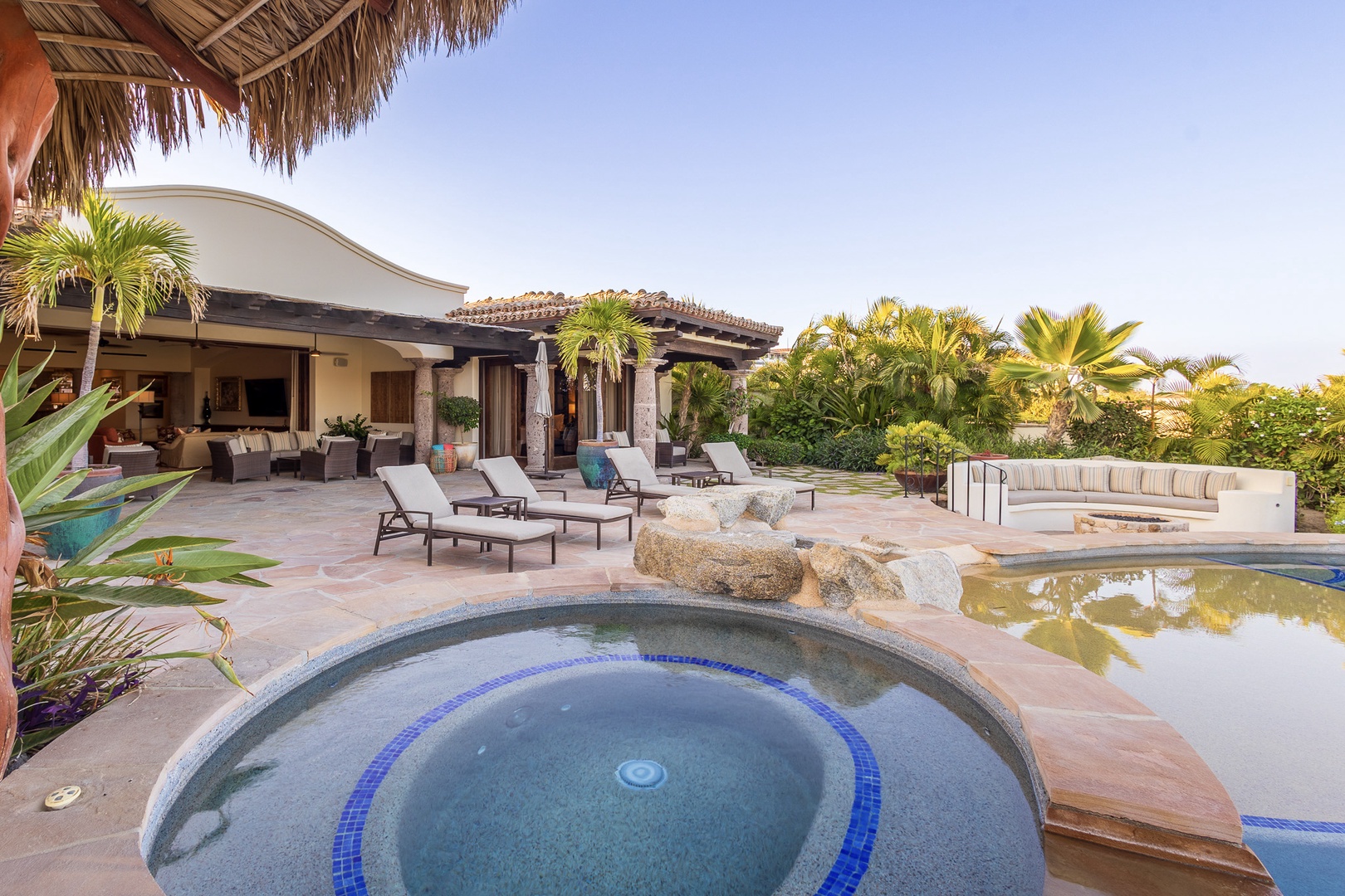 This tropical oasis offers sweeping ocean views, a bubbling hot tub, and plenty of loungers for lazy afternoons. Enjoy cocktails by the pool or gather around the fire pit as the sun sets.