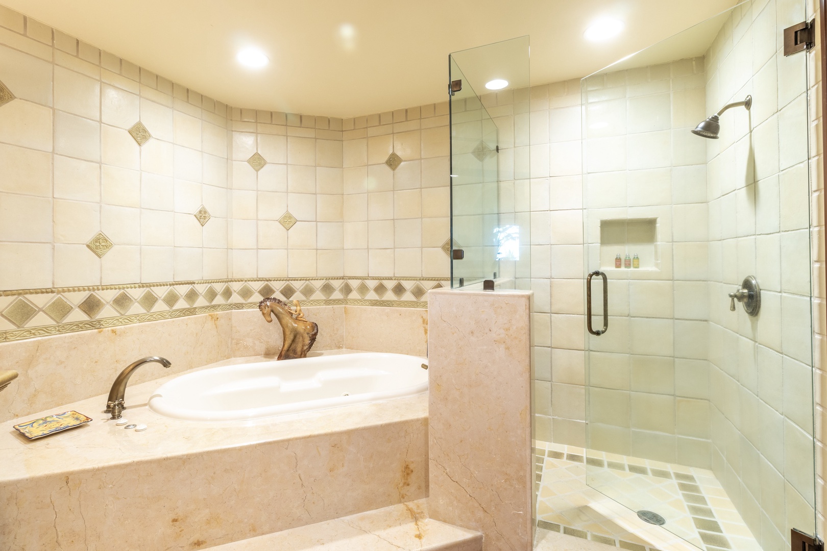 Pamper yourself in this elegant bathroom, complete with a luxurious soaking tub and a walk-in shower with glass doors, all bathed in warm, soothing light.