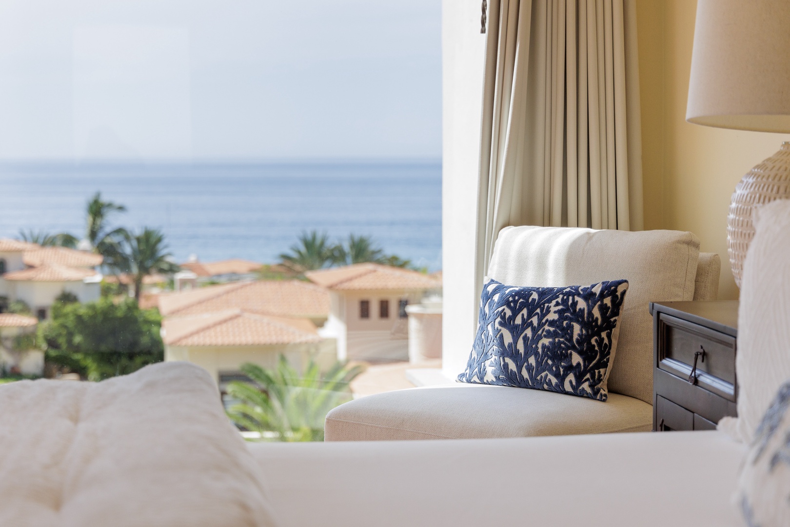 Sink into your cozy chair, gaze past swaying palms to the sparkling ocean beyond, and let the soothing coastal ambiance wash over you.