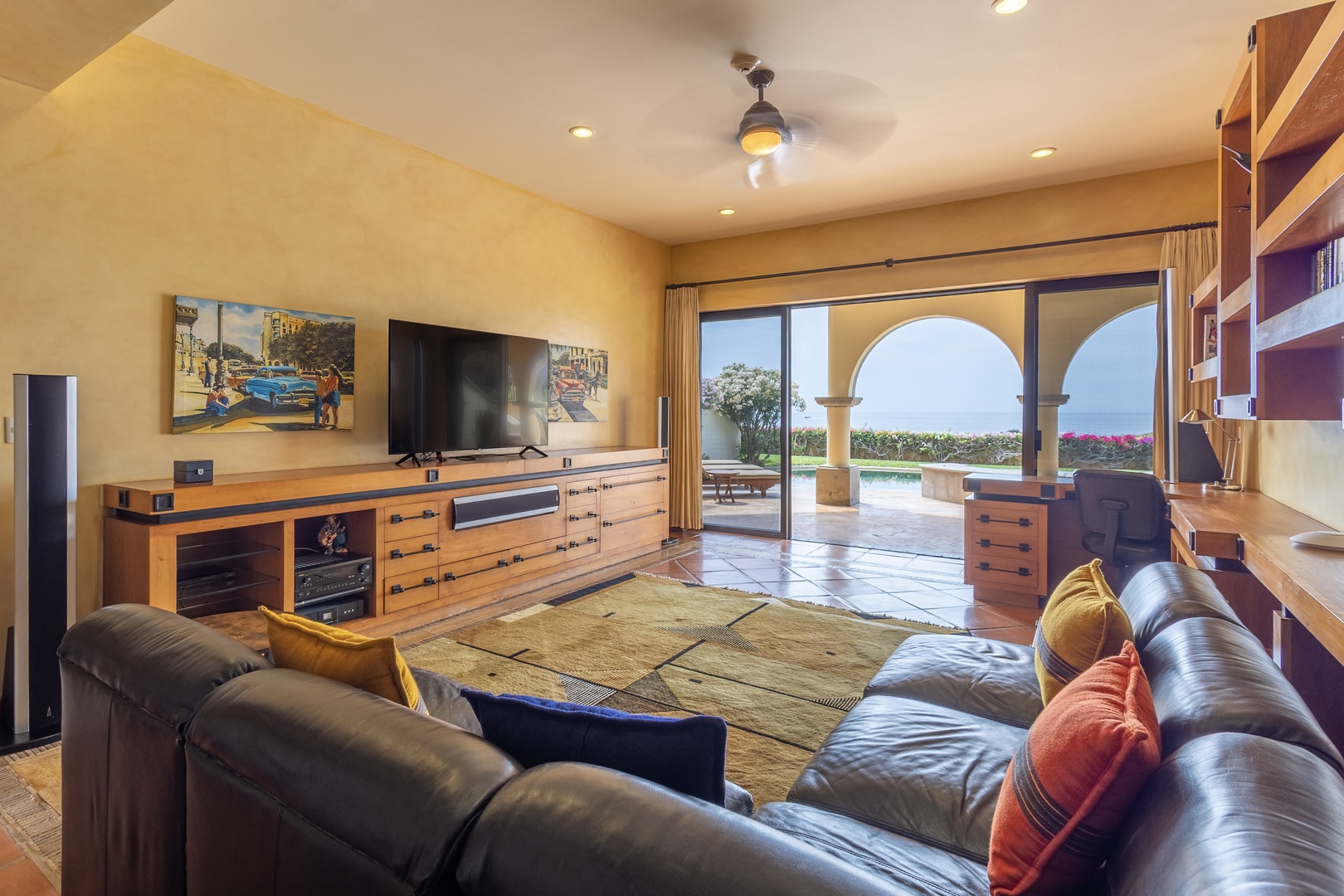 Sink into plush leather sofas, stream your favorites on the big screen, and let warm natural light flood in as you gaze out to your private pool and terrace beyond.