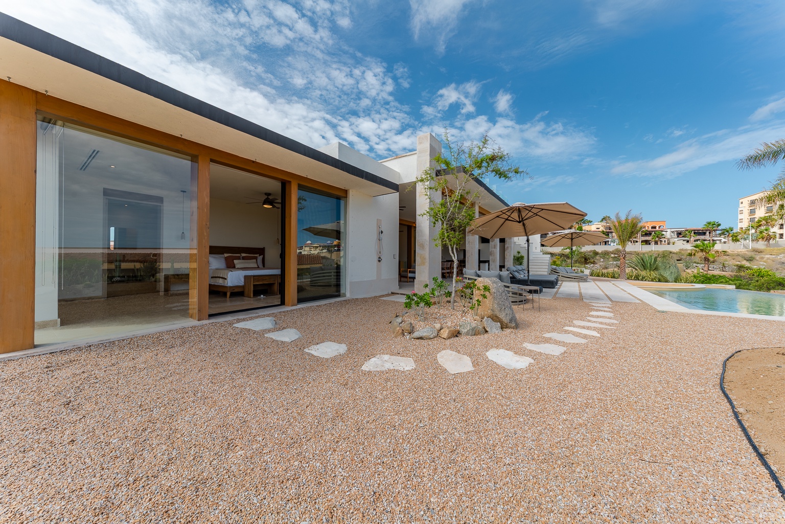Modern desert architecture meets resort-style living, with private pool access and sun-soaked lounging just steps from your sliding glass doors.