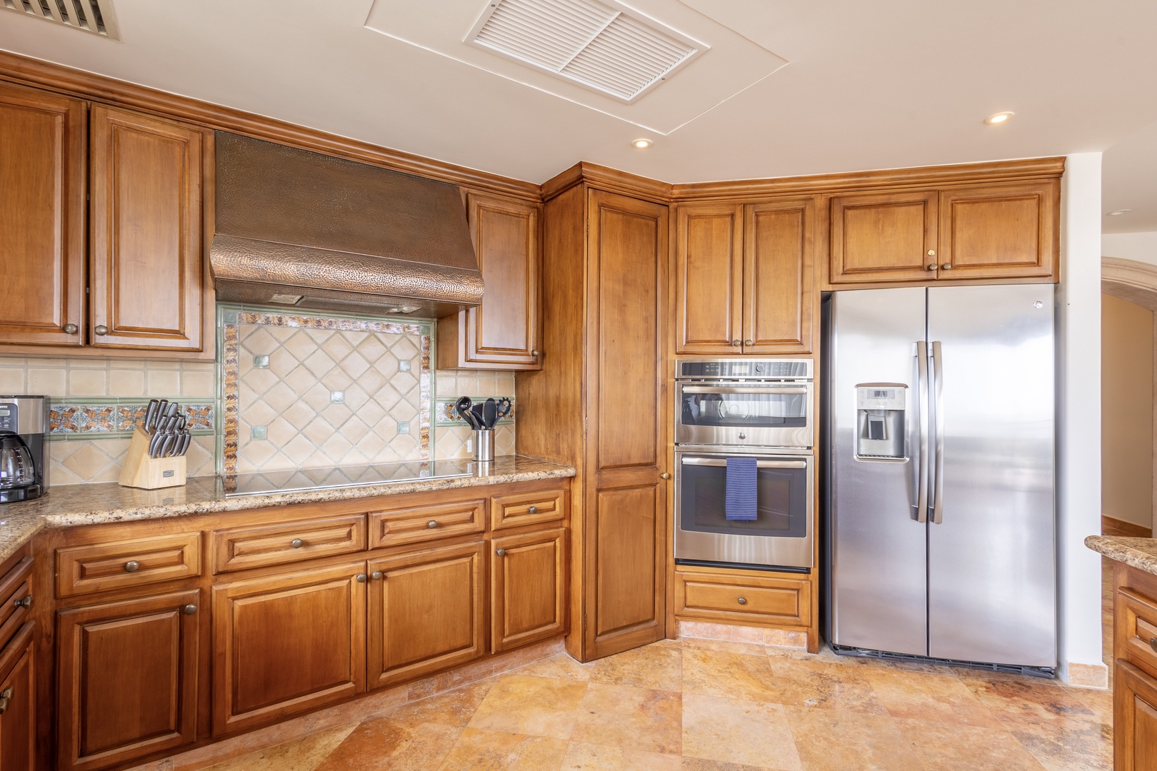 Your gourmet kitchen awaits with rich wood cabinetry, granite counters, and stainless steel appliances for memorable meal preparation.