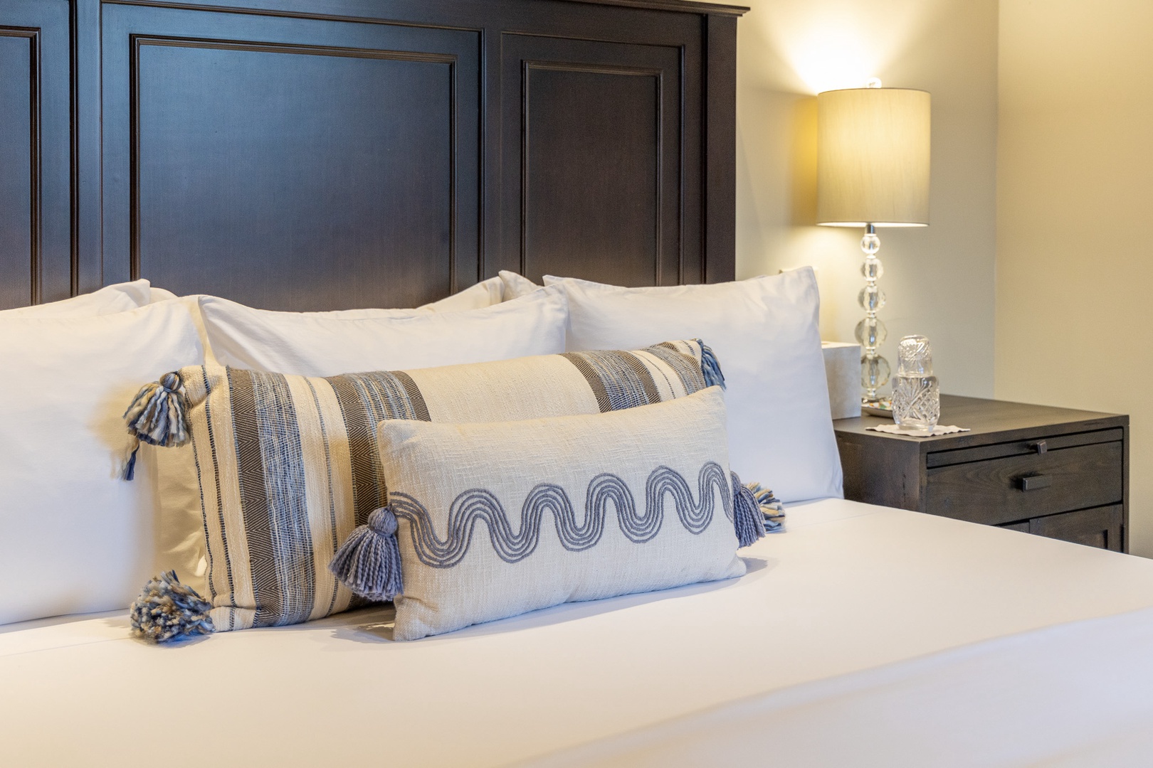 Sink into crisp linens and plush pillows after a day of exploring. Your restful retreat awaits, complete with elegant bedside lighting for late-night reading.